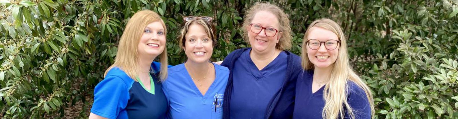 Image of four Anderson OP employees standing outside together.