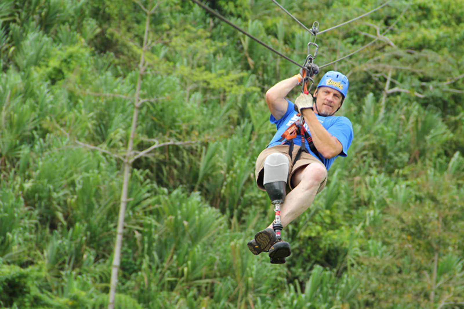 image of man with prosthetic leg on zipline